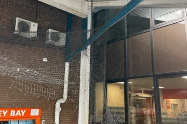 Before - Damaged Netting Hanging Over the Trolley Bay