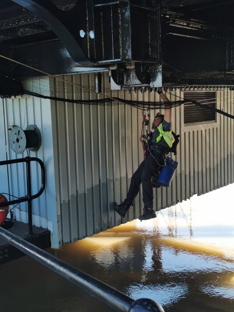 Bird netting installed using suspended rope access method